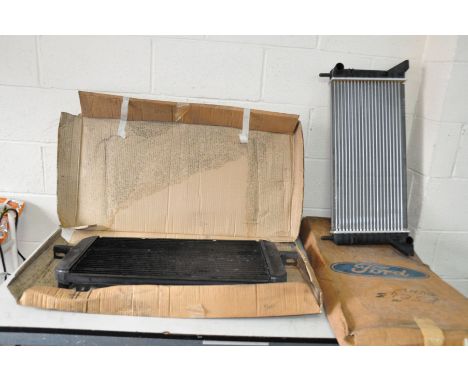 TWO VINTAGE CAR RADIATORS comprising of a Ford Escort Mk4 OVHV in original box and an aftermarket 1984-1990 Sierra Mk1 radiat