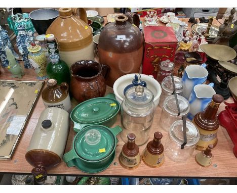 Two stoneware flagons, green enamel dishes, empty Wade Bell's whisky decanters and other items.