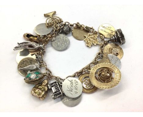 9ct gold charm bracelet with a collection of various gold and silver charmsTotal weight 63.3 grams25 charms: x11 silver/white