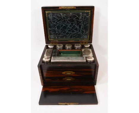 Mid-19th century coromandel dressing table box with fitted interior of glass jars and boxes with plated mounts, and fall-fron