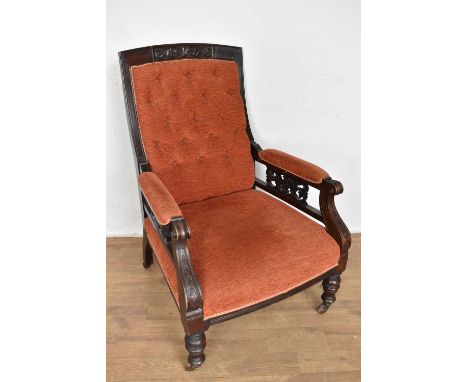 Victorian mahogany framed open armchair, with brick red button upholstery in square carved mahogany showwood frame on turned 