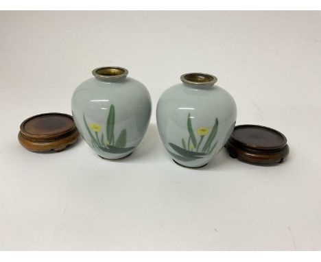 Unusual pair of Japanese enamelled vases on standsOne with a very light hairline near the base - otherwise in good condition.