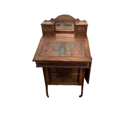 Late Victorian Davenport with leather lined slope and four side drawers enclosed by panelled door. The desk top slides out to