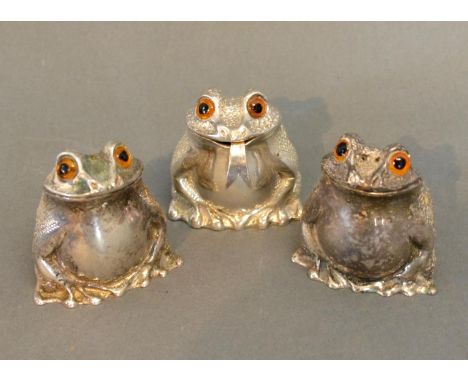A Set Of Three Condiments In The Form Of Frogs by Richard Commyns comprising salt, pepper and mustard, the mustard spoon term