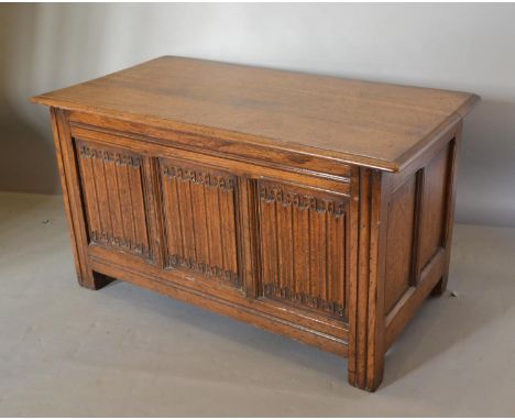 An Oak Coffer Of Small Proportions The Hinge Top above a three linen fold panel front flanked by stiles, 91 cms wide 