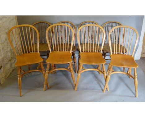 A Set of Four Reproduction Spindle Back Windsor Chairs, each with a spindle and hoop back above a panel seat, raised upon tur