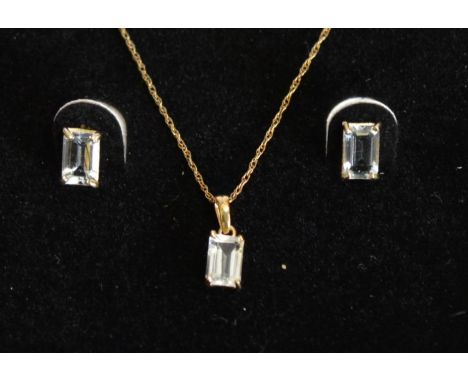 A 10 ct. Gold and Aquamarine Suite of Jewellery, comprising a pendant with chain and a pair of matching ear studs, all set wi