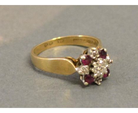 A 9 ct. Yellow Gold Diamond And Ruby Cluster Ring, set with four rubies interspersed with diamonds 