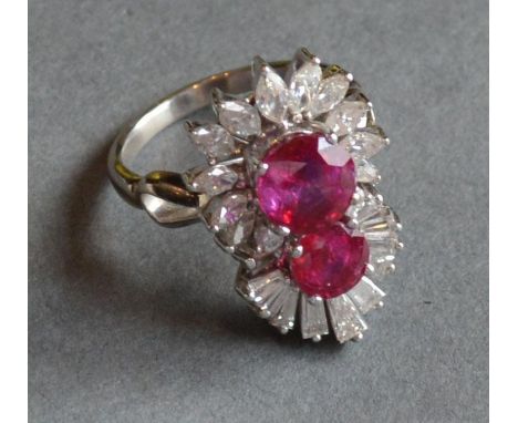 An 18ct. White Gold Ruby and Diamond Large Dress Ring set with two rubbies, surrounded by marquise and baguette cut diamonds 