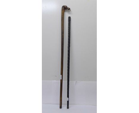An ebonised walking cane and a walking stick with carved dog's head, signed Kepkupa 