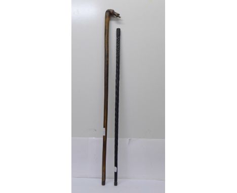 An ebonised walking cane and a walking stick with carved dog's head, signed Kepkupa 