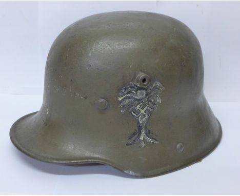 A WWI M16 German combat helmet with original liner with later applied markings 