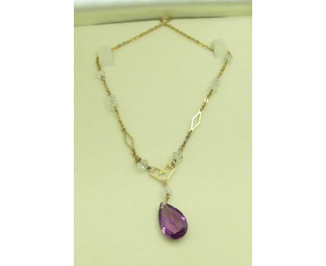 A vintage 9ct gold necklace set with 'crystals' and a purple drop 