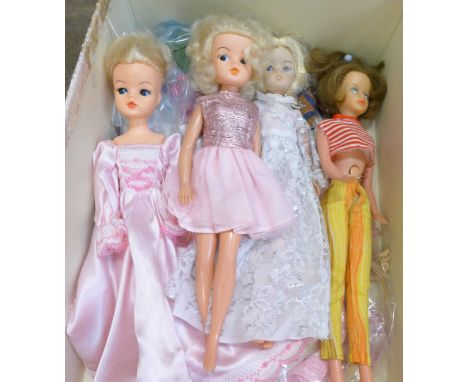 Four vintage dolls including Sindy, clothes and a later Sindy British Airways doll, boxed 