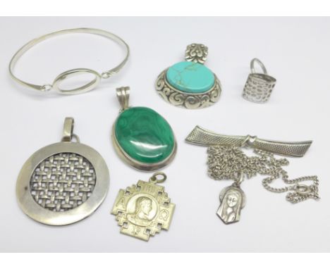 Three silver pendants, a silver bangle, a silver ring, etc. 