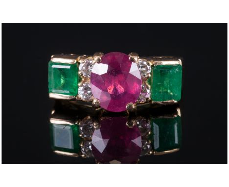 A Fine 18ct Gold Set Ruby & Emerald Ring with diamond spacers. The central faceted ruby of excellent colour. 1.5cts. With two