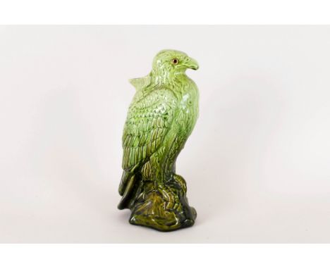 Ault Pottery Eagle Spill Vase with glass eyes and green ground. 11 inches high.