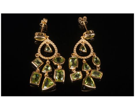 Peridot Pair of Chandelier Earrings, 10.5cts of peridot in a variety of cuts, suspended from gold vermeil and silver ovoid ho