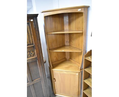 An Ercol mid stain corner shelf with cupboard under, a few light knocks and marks as shown and generally in good condition
