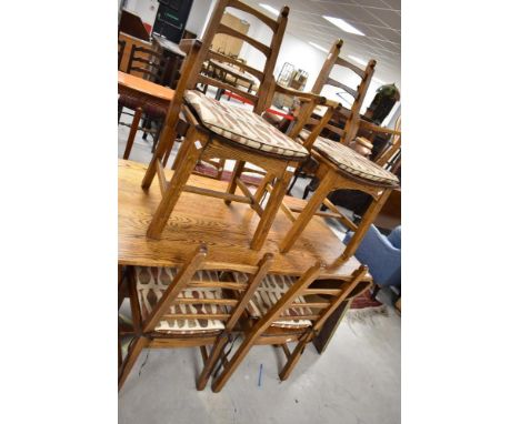 A traditional oak craftsman made Arts and Crafts style refectory style table with drop leaves to ends, and set of six (four p