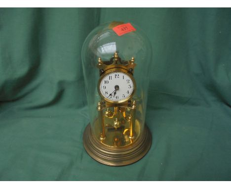 Glass domed table clock in brass on metal style base possible 1930's