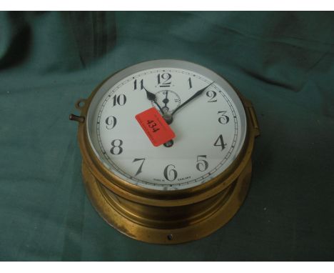 Brass bulk head clock with enamelled face, manufacturer Tempurer, made in England