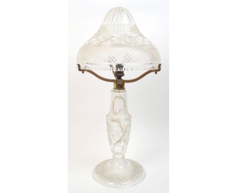 An Edwardian crystal table lamp the mushroom shade supported by three gilded metal supports, 54cm high