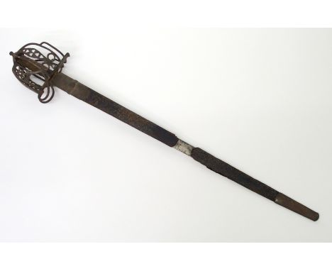 A Victorian Scottish basket hilt sword the steel basket with pierced hearts, sharkskin grip and domed pommel, single fullered
