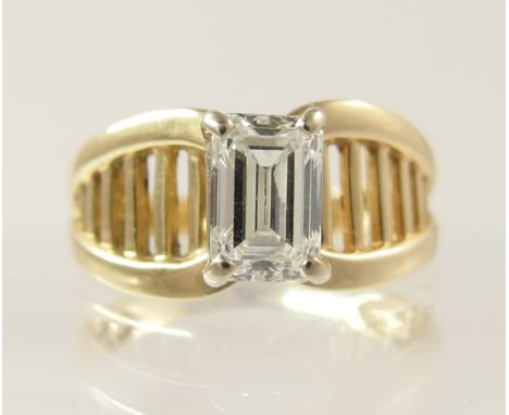 A 0.90ct emerald cut diamond retro ring by Stuller one of the premier manufacturers in the USA since 1970. This ring features