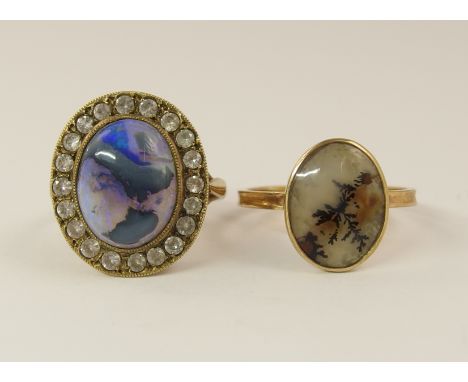 Two vintage rings a boulder opal ring, mounted in yellow metal surrounded with clear gems finger size approx K, and an early 