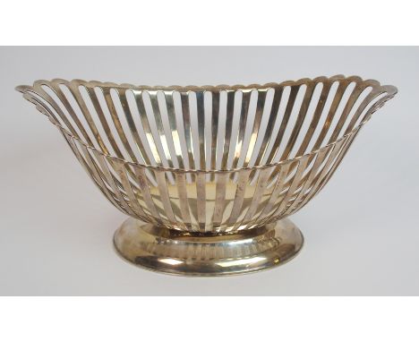A silver bread basket by William Hutton & Sons Limited, London 1910, of boat shape with slatted sides on convex pedestal base