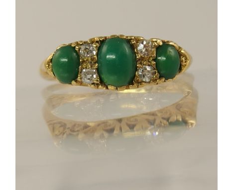 An 18ct turquoise and diamond ring set with four old cut diamonds to the traditional scroll mount hallmarked Chester 1905, fi