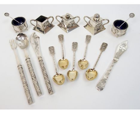 A Chinese silver three piece cruet decorated with dragons, stamped MT, 7cm wide, a pair of circular salt cellars stamped TC, 