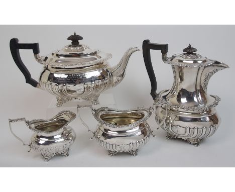 A four piece silver tea service by Thomas Bradbury & Sons Limited, London 1901, of rounded rectangular form with foliate embo