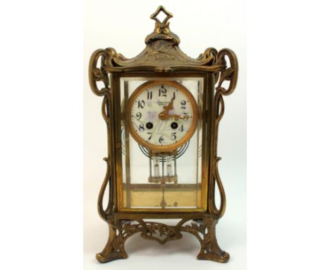 An Art Nouveau cast brass repeating mantle clock probably French circa 1900, the whiplash decoration to each corner with cast