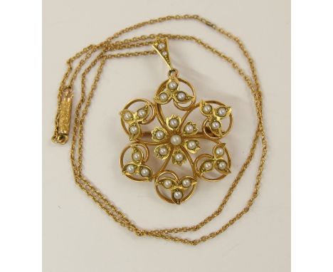 A 15ct Edwardian pearl set pendant brooch with central flower motif surrounded by leaves, with a vintage 9ct chain