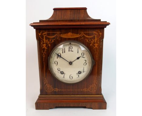 An Edwardian rosewood mantle clock the white enamel dial within inlaid floral design, German movement striking on two coiled 