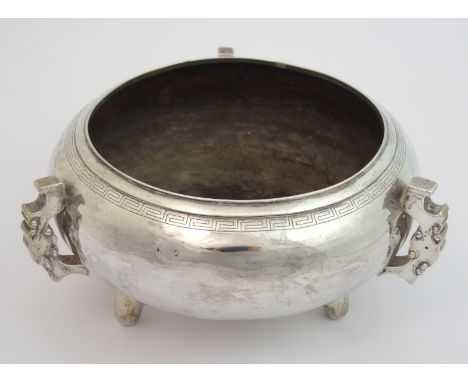 A Chinese silver archaic style censer with key pattern band above three scroll handles on three splayed feet, stamped marks, 