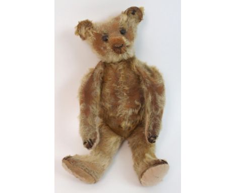 An early Steiff centre-seam Teddy bear with early Steiff button in ear, stitched muzzle, claws and paws, pads repaired, other