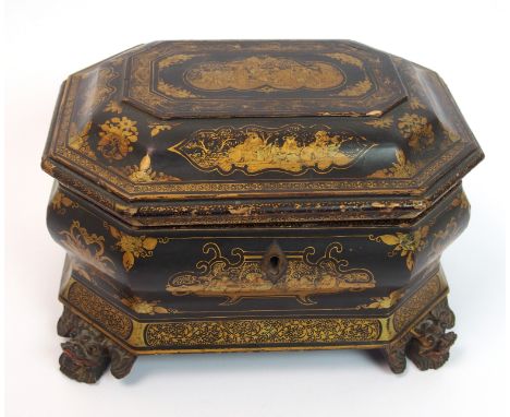A Chinese export black and gold lacquered octagonal shaped tea caddy painted with vignettes of figures in gardens divided by 