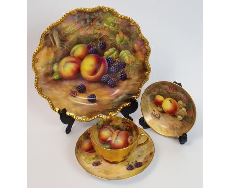 A Royal Worcester fruit decorated cup, saucer and plate signed Flaxman the cup painted with plums and grapes signed Flaxman, 