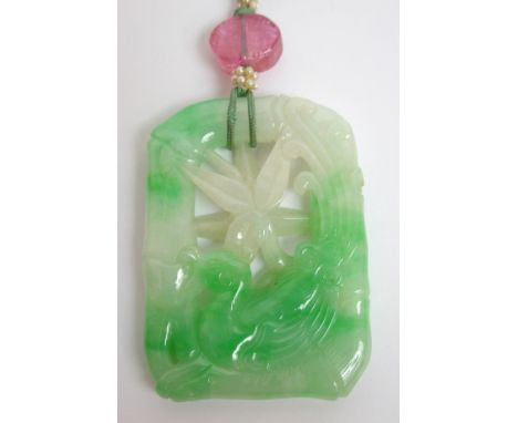 A Chinese jade pendant carved and pierced with a pheasant within a bamboo shaped surround, 6cm wide