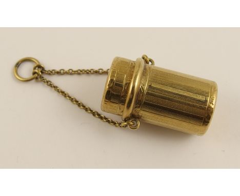 A 14ct Tiffany pill box with suspension chain the engine turned and hand engraved body has a flip top lid revealing the Tiffa