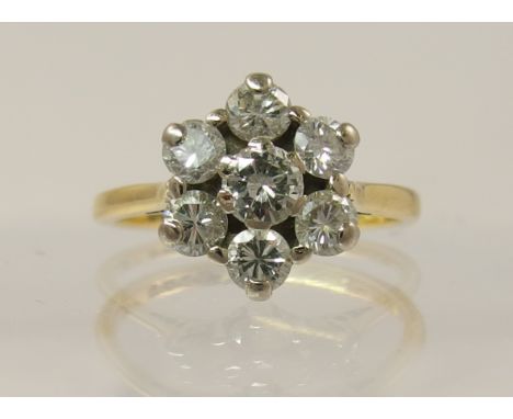 An 18ct gold diamond flower cluster ring of an approximate estimated total 0.78cts set to basket mount and tapered tubed shan