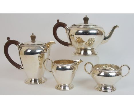 A four piece silver tea service by Wakely and Wheeler, London 1956, of tapering cylindrical form with gadrooned border on ste