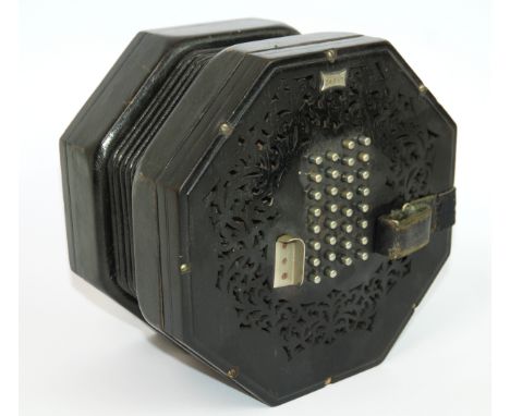 A Victorian Wheatstone sixty-four button concertina with hexagonal pierced ends, No. 24667, stamped C. Wheatstone & Co, Inven