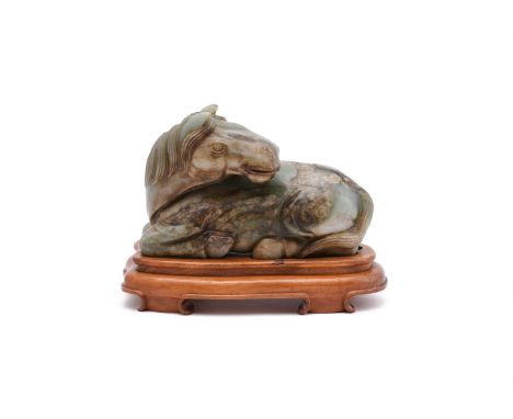 A LARGE JADE MODEL OF A RECUMBENT HORSE20TH CENTURY The jade with brown and white inclusions, in Qianlong style and with apoc
