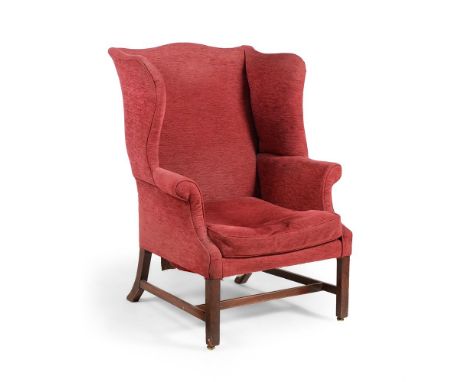 A GEORGE III MAHOGANY WING ARMCHAIRLATE 18TH CENTURYThe front legs with brass castors111cm high, 82cm wide, 74cm deepConditio