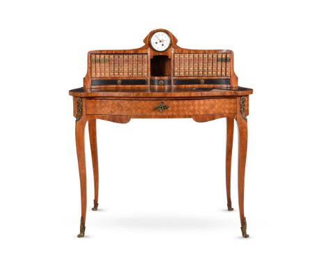 A FRENCH DRESSING TABLE IN LOUIS XVI STYLE19TH CENTURYWith clock dial raised above two banks of falsebook bindings, pigeonhol