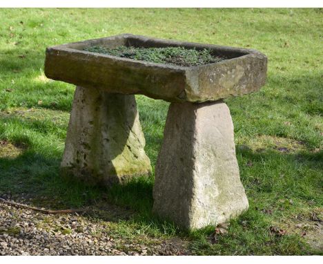 A LIMESTONE RAISED PLANTER OR BIRD BATHComposed of a rectangular shallow trough raised on two square section staddle stones73